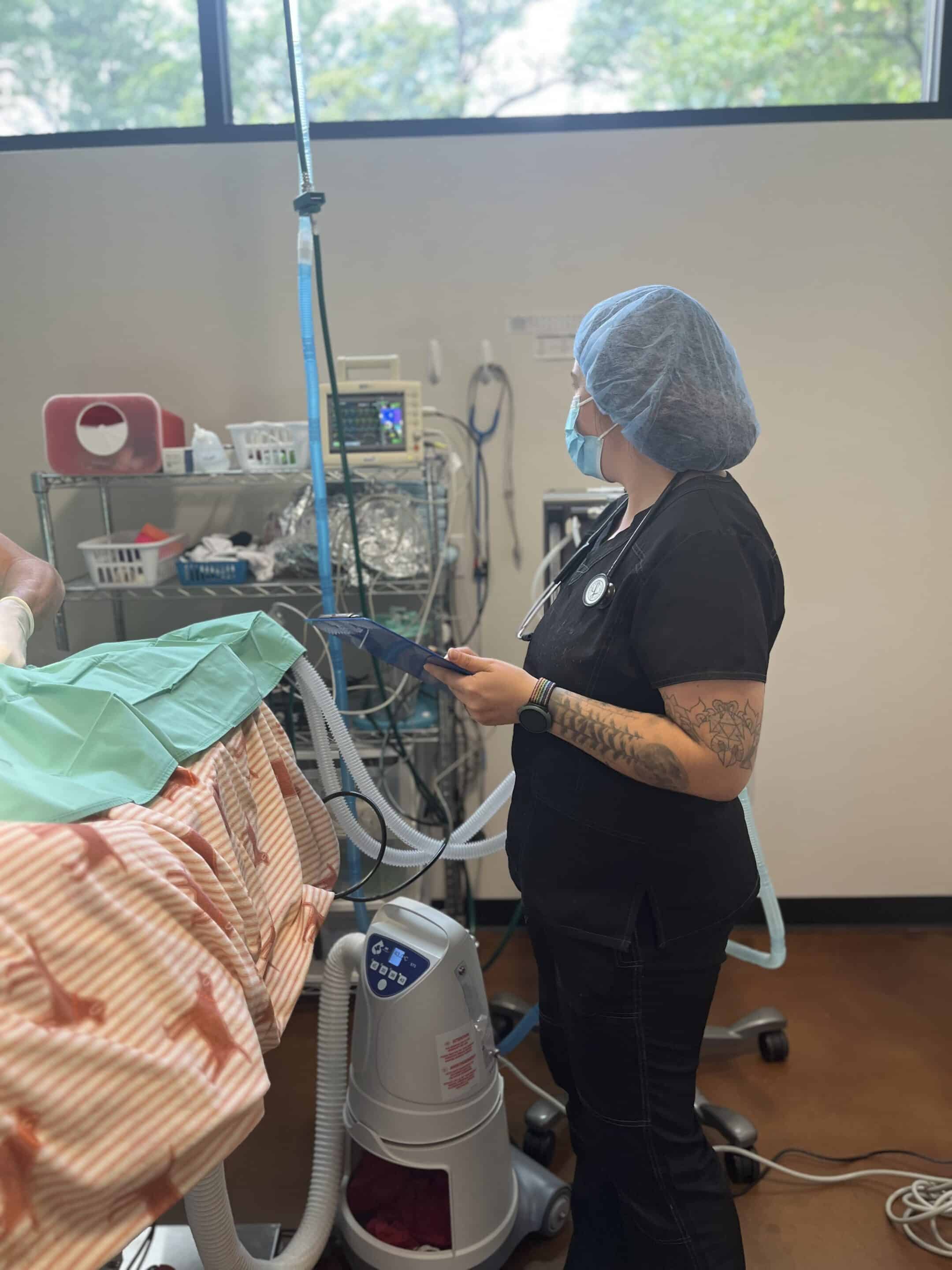 A vet standing next to a monitor.